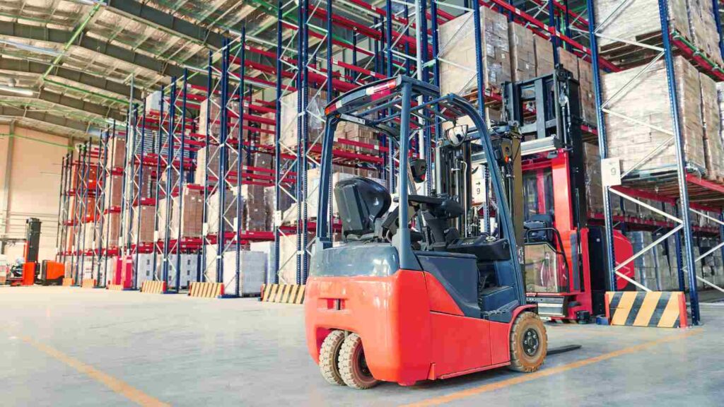 A forklift in the background of a warehouse prepared to work for a forklift operator in the Netherlands.